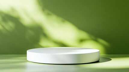 White Circular Pedestal with Shadows on a Green Background