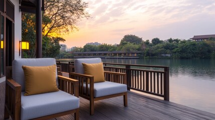 Obraz premium Tranquil Outdoor Seating Area Overlooking Water at Sunset, Ideal for Wellness Retreat and Relaxation