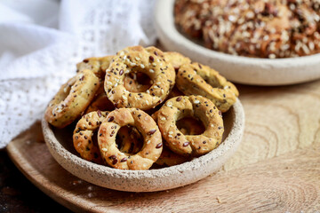 Cookies with grains and herbs in the shape of miniature pretzels. Homemade recipe.