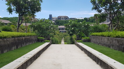empty path in the garden looking towards the hotel resort