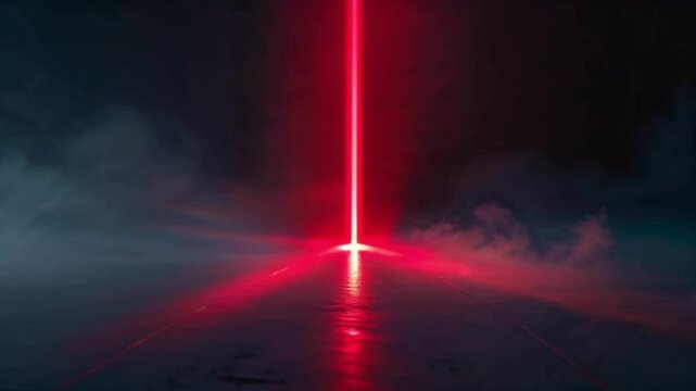 the tip of a red laser beam that cuts through the dark shadows