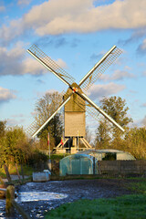 Vintage wind mill on Flemish countryside