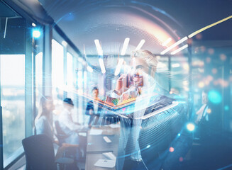 Abstract sci-fi double exposure image. A woman uses a tablet in a modern office, futuristic elements overlay the scene, creating a dynamic background.