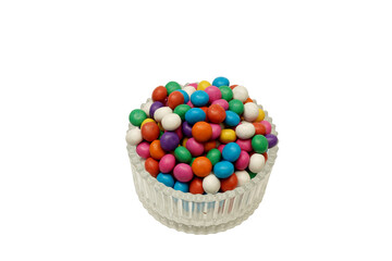 Colorful biscuit ball candy served on transparent glass bowl. Isolated on white background 