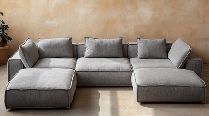 A Modern, Gray Modular Sofa Sits Against A Textured, Beige Wall. Sunlight Streams In, Highlighting The Sofa'S Fabric.  The Scene Is Calm And Inviting.