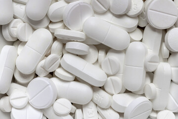 background of various white pills and pills of medicines