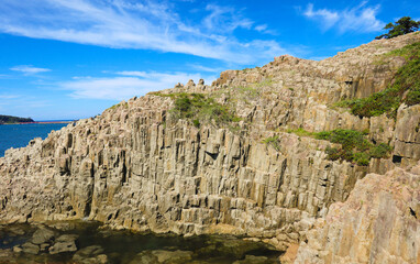 Landscape A close-up view of the dramatic columnar jointing of the Tojinbo Cliffs, showcasing the...