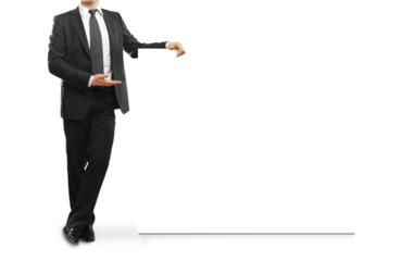 A businessman in a formal suit presenting an empty white board, isolated on a white background. Concept of presentation, template, or layout