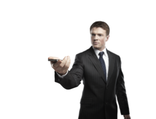 Businessman in a formal suit holding a smartphone, extending his hand forward, isolated on a white background. Concept of technology and communication