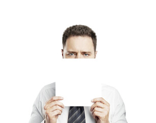 A man in a formal shirt and tie holding a blank white paper, covering part of his face, isolated on a white background, concept of mockup or template