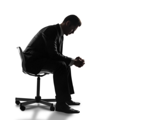 Silhouette of a man in a suit sitting on a chair, leaning forward with clasped hands in a contemplative pose, isolated on a white background