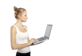 Woman in a white tank top holding and typing on a laptop. She stands isolated on a clean white background. Concept of technology and productivity