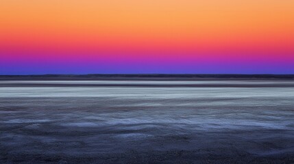 Obraz premium Stunning Sunset Over Calm Water with Vibrant Colors in Sky