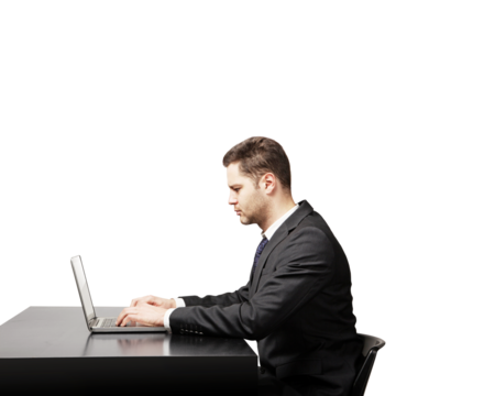 Businessman in formal suit typing on laptop at desk, isolated on white background. Professional work concept, clean minimalist layout - Powered by Adobe