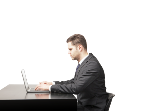 A man in a suit focused on typing on a laptop at a desk, isolated on a white background. Concept of professionalism, productivity, and work