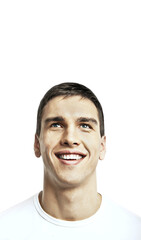 Fototapeta premium Close-up of a happy young man smiling and gazing upwards. Isolated on a clean white background. Concept of positivity and optimism