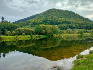 Autumn landscape of river and mountains, rural area in Ukraine