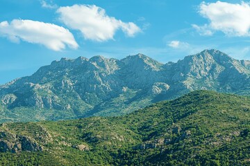 Fototapeta premium Beautiful picturesque green mountains against the blue sky.