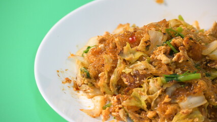 stir fried sukiyaki with egg and pork on white plate