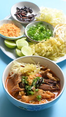 rice vermicelli with northern thai curry sauce on blue background