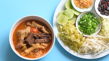 rice vermicelli with northern thai curry sauce on blue background