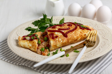 Omelet with chicken, rice and vegetables.