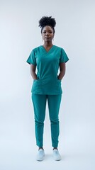 Fototapeta premium A medical doctor in scrubs, standing confidently with a white background