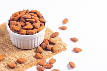 Large assortment of nuts in different bowls on stone table.