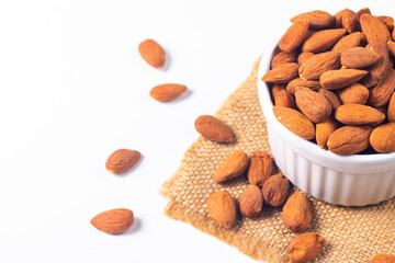 Large assortment of nuts in different bowls on stone table.