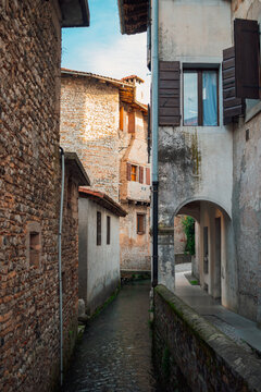 Alley in Valvasone with a small river
