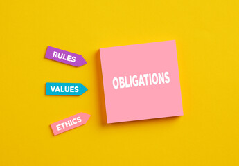 The word obligations on pink note paper. The components of business company obligations rules, values and ethics.