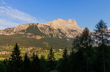 Dolomites alps with trees in front and mountains rock in the background