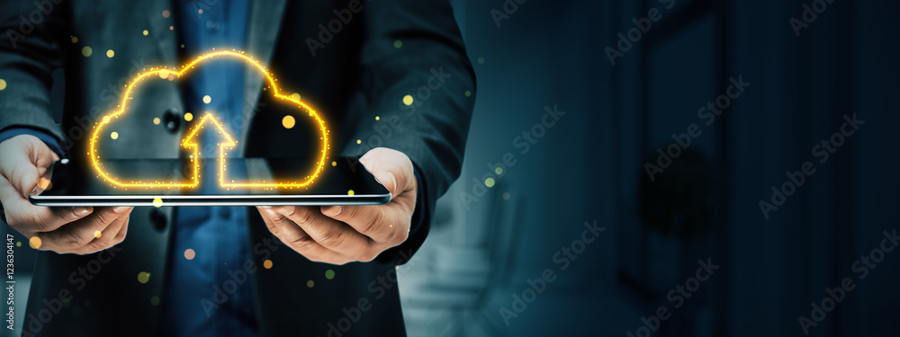 Poster Businessman holding tablet with glowing cloud upload symbol on dark background. Concept of cloud computing, data storage, and technology.