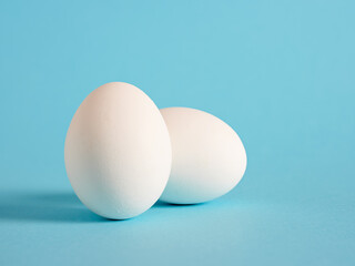 White eggs on blue background.