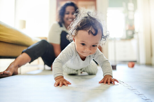 Mother, family and baby crawling on floor in living room learning to walk, child development and motherhood. Love, home and happy mom and kid for bonding, quality time and relax together on floor