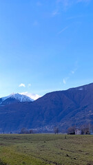 Fototapeta premium Beautiful mountains against a blue sky. Vertical image of majestic mountains.