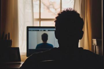 Teletherapy session with a person talking to their therapist on a laptop