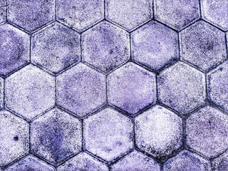 A tightly-knit array of hexagonal tiles creates a textured surface, each tile bearing a unique...