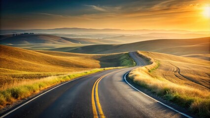 Fototapeta premium A winding road through rolling hills bathed in the warm glow of a setting sun