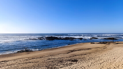 The ocean shore. Beautiful blue sky over the ocean. Beautiful sea waves. Horizontal image.