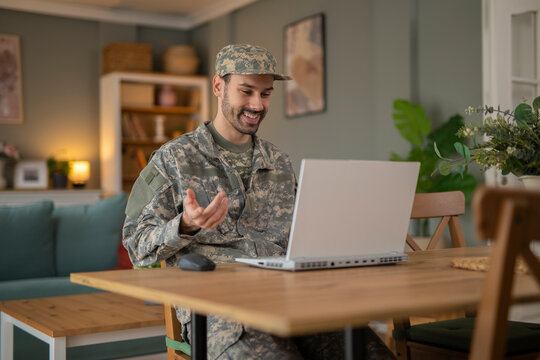Military man using laptop and having video call