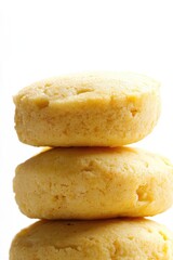 Fototapeta premium Four freshly baked cookies stacked in a row on white background.