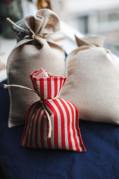 Three decorative burlap sacks in a windowsill 