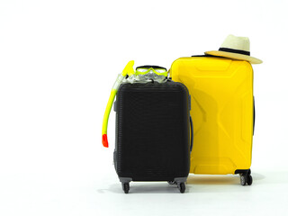 Summer travel concept. Colorful snorkeling mask, straw hat with a black stripe, yellow and black suitcase on white background. (Studio Shot)