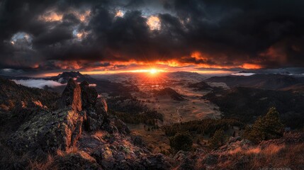 Fototapeta premium Fiery sunset over mountain valley, dramatic cloudscape