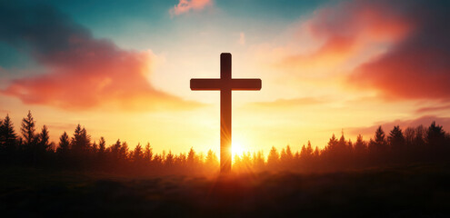 silhouette of cross against vibrant orange and blue sunset, surrounded by trees, evokes sense of peace and reflection