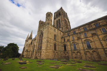 Fototapeta premium The ancient and grand Durham Cathedral with its historic cemetery and iconic Norman architecture, a renowned tourist attraction in the UK.