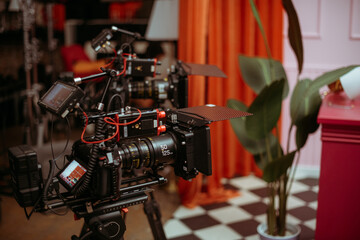 Professional cinema and video camera on the set. Shooting shift, lighting fixtures, shooting equipment and the team.