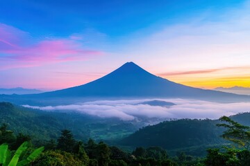 Fototapeta premium Mysterious Mountain Shrouded in Thick Fog with Low Hanging Clouds Creating an Enigmatic and Serene Atmosphere in Untamed Natural Wilderness