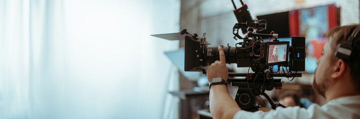 Professional cinema and video camera on the set. Shooting shift, lighting fixtures, shooting equipment and the team.